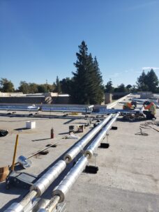 2 workers welding straight pipe