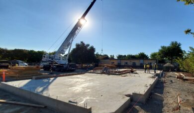 Whole site into sun behind crane - good